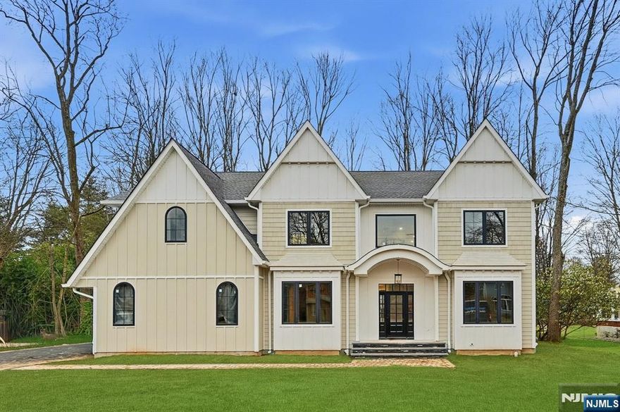 Welcome to this luxurious new-construction 6-BR, 6.5-bath Center Hall Colonial set on a level 0.38-acre lot in one of Florham Park's most sought-after neighborhoods. A custom luxury-grade statement front door introduces the exceptional craftsmanship throughout. The grand 2-story foyer is flanked by formal living and dining rooms.The sun-filled double-height family room with floor-to-ceiling windows is anchored by a gas fireplace and flows seamlessly into the chef's kitchen featuring premium panel-ready appliances, a large quartz center island, quartz backsplash, walk-in pantry, bar area, and breakfast area. Arch glass doors open to a paved patio and expansive backyard, ideal for indoor-outdoor living. The main level includes a private en-suite bedroom with walk-in closet, ideal for guests, a powder room with Carrara marble vanity, dedicated home office, mudroom, and direct access to the two-car garage. The second level offers 4 en-suite bedrooms, including a luxurious primary suite with dual walk-in closets and spa-inspired bath, plus a convenient laundry room. The fully finished lower level adds a recreation room, media lounge, bedroom, and full bath.Enhanced by custom millwork, designer lighting, refined architectural details, and exceptional curb appeal, this home is ideally located near shopping, dining, commuter routes, library, recreation facilities, and top-rated schools. Low taxes and a 10-Year Builder Warranty complete this offering.