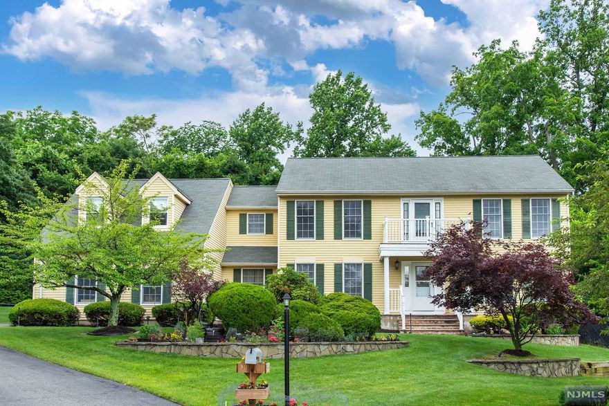 This large well kept Colonial is situated at the end of a double cul de sac on one of the nicer streets that Wayne has to offer. This house has a true extended family suite with separate entrance, kitchen, large Living Room and large Bedroom with full bath. Hardwood flooring throughout entire home. The main house has a large Eat In Kitchen with sliders leading to a large composite deck and a private back yard with a 20X40 Ft Inground salt water pool, great for entertaining. Two zoned Central AC systems, Five Zone HW BB, whole house water filter system. This home is a must see!!!