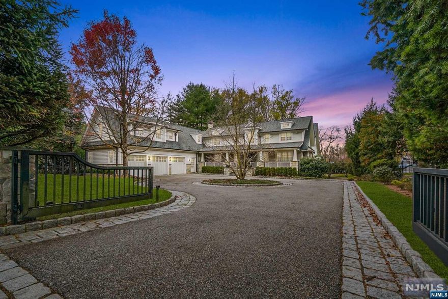 Stunning Hamptons style home set back on 3/4 +/- acre in sought after E.Hill of Demarest. Enter the gated circular DRVWY where mature trees offer utmost privacy & a sprawling covered front porch conveys sophisticated luxury. The EF exudes elegance w/gas fpl, radiant HTD floors & exposed pine columns.An expansive gourmet EIK ft brazilian walnut cabinets, honed MRBL counters, Viking appliances, addl fridge drawers, DW & addl DW drawer. Oversized center island & sunny BKFST area w/fpl make this house feel like a home. Convenient homework area, W/I pantry & lrge mdrm w/2nd staircase lead to heated 3 car GAR. Entertain in style in the sun filled DR & generous FR w/coffered ceiling. Custom LDRY w/dbl W/D & 2 1/2 BTH complete the 1st flr. The primary suite built w/every detail; an office & a spa-like bath with his/her sides. DBL vanities, 2 water closets, 2 WIC, STM SHWR & JACZ. 4 addl generous bdrms, theater rm & gym/6th bdrm w/full BTH on 2nd fl. Minutes from NYC & Top rated Schools.