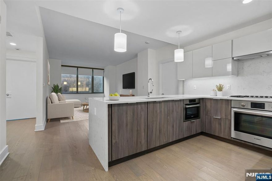 Endure in high-end luxury with the most desirable building, Nine on the Hudson, along NJ Gold coast area. This immaculate 2 bed + den and 2 full bath is sure to please featuring an open layout floor plan covering 1,194 sqft. Walk into the modern kitchen featuring Aspen quartz countertops, Pedini cabinets, Bosch appliances, & Thermador fridge which opens to the living, dining, and the Den perfect for an office or play area. The master en-suite features a custom California walk-in closet and the generous size second bedroom & custom closet. The home also features wood flooring throughout, in-unit washer/dryer, 1 car garage parking, and oversized windows. Community offers breathtaking views of NYC with 40,000 sqft of resort-style amenities featuring 24-hour doorman, state-of-the-art fitness center, amenity deck with infinity swimming pool and BBQ area, rooftop deck with cabanas, shuttle to/from Ferry. You don't want to lose out on this one!