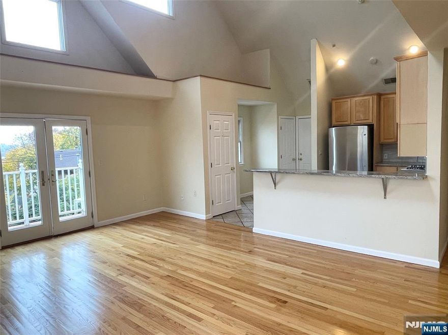 Beautifully designed open-concept kitchen and living room featuring vaulted ceilings and a cozy fireplace. Enjoy a small balcony with stunning Hudson River views. The primary bedroom offers a walk-in closet and private bath, while the second bedroom provides direct access to the backyard. A spacious open loft serves as a third bedroom or flexible living space. Located in the heart of Edgewater, this home boasts gleaming hardwood floors, abundant closet space, and includes both a garage parking space and a carport. In unit washer & dryer. Conveniently close to fine dining, shopping, and easy transit options to NYC. An exceptional home in a prime location! Owner has a NJ real estate license.