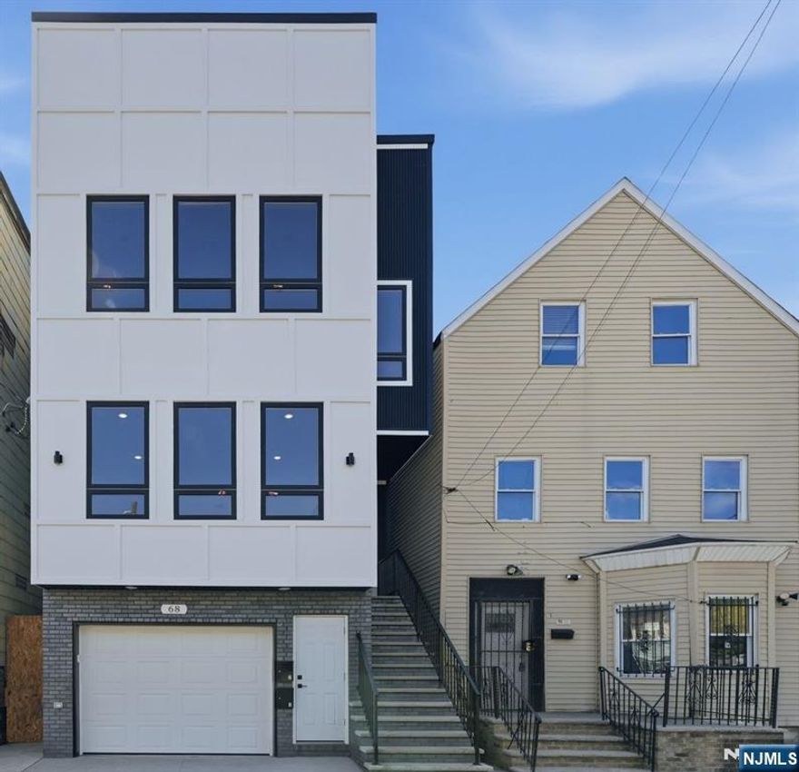 Welcome to this BRAND NEW CONSTRUCTION! Each unit is thoughtfully designed with a primary bedroom, two additional bedrooms, and two full bathrooms, along with in-unit laundry hookups for everyday ease. The layout offers a comfortable balance of connection and privacy, making everyday living feel both functional and inviting. The first unit also features direct garage access and a finished recreation room that is perfect for movie nights, celebrations, a home office, fitness space, or simply unwinding after a long day. Step outside into the fenced backyard where outdoor gatherings come naturally, and quiet moments feel like your own private retreat. With off-street parking and a layout designed for flexibility and comfort, 68 Sherman offers a place where everyday living and meaningful moments come together.