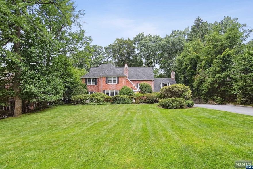 Stately Colonial house nestled on flat half acre. Prime location on the East Hill. Fully renovated blending a modern aesthetic with the classic. Entry foyer leads to bright & airy formal living room featuring a fireplace & built-ins. Large Formal dining room looks out on expansive backyard. Family room with french doors leads to a Flagstone patio perfect for outdoor entertaining. Chefs Kitchen with windowed circular dining area, Maple cabinetry, top of the line appliances include a Viking range & sleek countertops. Modern Powder room. The second level's recent Primary bedroom suite addition boasts an ensuite Spa bathroom, large soaking tub & 3 large closets, 1 walk-in. 4 addl bedrooms; 1 has new ensuite bathroom, 1 with fireplace, & an additional bathroom. The third level has 2 bedrooms, an office & 1 full bathroom. Conveniently located 5 minutes to GWB & Downtown Englewood shopping. Close to all houses of worship