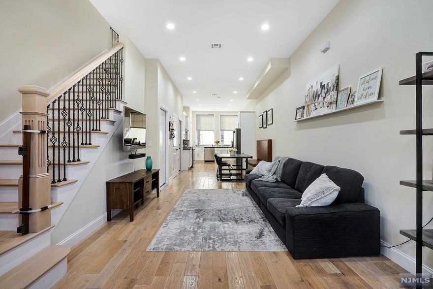 Impeccably stunning SF home with everything you could ask for! Just 3 years young, sitting along a tree-lined street on the corner of Washington Park, this 2,000sf, 3BR/3.5BA home moves across 3 levels of perfectly laid out space. Enter inside the open floor plan of the main level featuring a seating area, LR, DR, & kitchen. Spacious gourmet kitchen with a farmhouse sink, granite counters, vast storage & large pantry. The upper level consists of 2 BRs with a full BA. Ground-level living space can be used for any desire & has direct access to your fenced-in patio. Oversized windows, wood flooring, & customization of all 3.5 baths are the spectacular highlights. In/unit W/D, garage parking & driveway. Tax abatement w/ 2 years remaining. From the liveliness of Union City with restaurants, stores, recreation, & NYC transportation at your doorstep, this is truly an enthralling home that will take your breath away at every detail, in one of the most sought-after & outstanding locations!