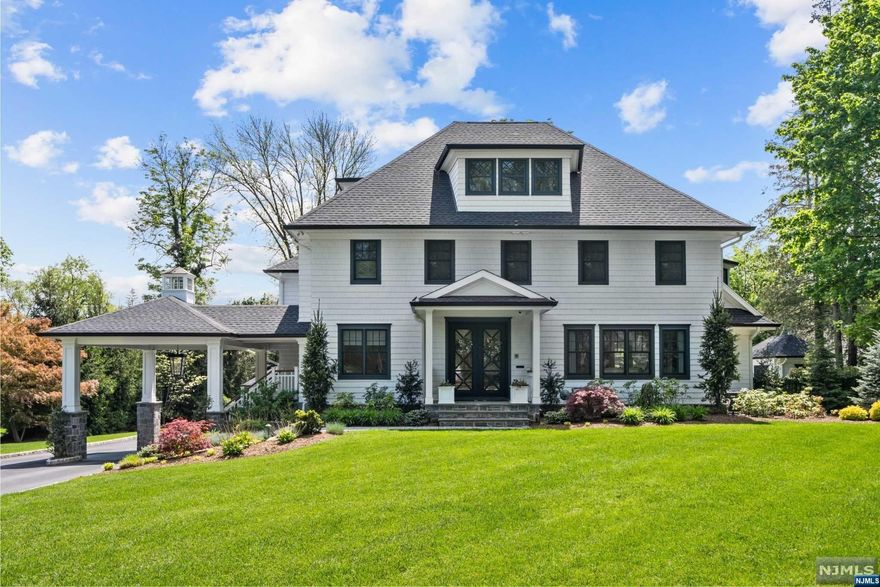 Modern masterpiece with 7,200 SF of design perfection situated in one of Ridgewood's most prestigious neighborhoods. Designed by renowned architect Jordan Rosenberg, this 2020 built colonial offers smart home features just a tap away, soundproofed infrastructure, designer finishes, and superior flow and functionality. Energized main level features massive windows, lofty coffered ceilings, radiant heated floors throughout, and sleek custom accents. Notables include the gourmet kitchen with high-end appliances with custom Tiffany blue enhancements and stunning refrigerator surround, trendy oversized mudroom, and banquet-sized dining room with a custom-built walnut wine room. All 4 second-level bedrooms are ensuite, including the luxurious primary suite with a spa-like bath and oversized walk-in closet. A huge finished basement, grand living spaces, covered stone porch with fireplace, stunning gunite pool with spa, pool house, sleek garage and so much more. A true must-see!