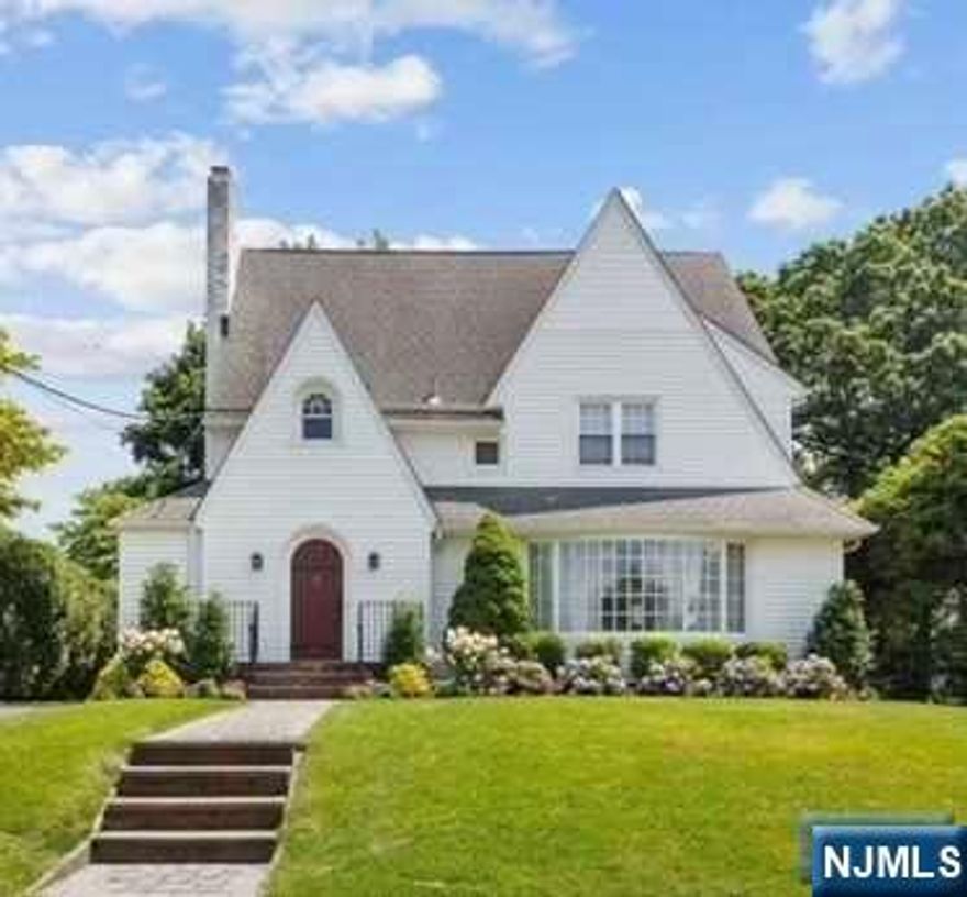 Welcome to Glen Rock! On a coveted street, enter this classic Tudor colonial exuding timeless sophistication and comfort. Expanded and renovated throughout (sparkling new powder rm), enjoy the natural light and rich hardwood floors highlighting features such as the fireplace and charming built-ins in both the living room and family rm. A substantial gourmet kitchen with prep island will inspire. Upstairs find a spacious bedroom, hall bath, 2nd bedroom w/en suite powder room,and a primary suite complete w/walk-in closet and fabulous full bath boasting double vanity w/ample stall shower. Upstairs on the 3rd floor, find a generous 4th bedroom with door to attic that can be finished. Down in the basement, find a fabulous finished rec room with half bath, laundry, storage, and utility room. Head outside from the dining room through french doors to a wood deck with access to backyard and the detached extra wide, deep 2-car garage. Close to NYC bus/train, this home checks all the boxes!