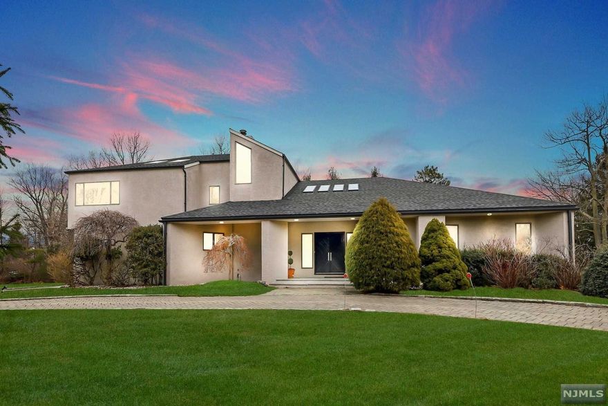 Luxurious custom contemporary, south-facing home in one of the most desirable areas of Alpine, Glen Goin Estates! This one of a kind home is set on one plus private, park-like acres. Spacious & open floor plan is perfect for entertaining family & friends. Generous two-story entry foyer, open dining room, grand formal living room w/ wood-burning fireplace, walks out to the two-tier deck. Beautiful modern kitchen has a large center island, breakfast area & custom Italian cabinetry. Large en-suite master bedroom & add. bedroom suite completes the 1st floor. 2nd level offers an elegant great room w/ vaulted ceilings, 3 bedrooms, 2 full baths, charming study & lg walk-in attic. 3 car garage w/ circular paver driveway & full house generator. Enroll your children in the illustrious Swim Club, Alpine Schools, Tenafly's Blue Ribbon HS & low taxes! Easy commute to the Hill Schools. Mins to the GW Bridge, transportation & Golf Courses. Forbes has rated Alpine one of the wealthiest zip codes!