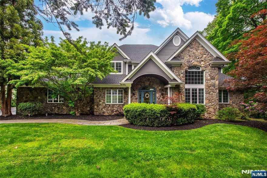 Tucked away in a quiet cul-de-sac on 1.23 acres, this stunning home offers luxury, comfort, and privacy. A welcoming front porch leads into a grand 2-story foyer with radiant heated floors. The gourmet kitchen features granite counters, newer appliances, a walk-in pantry, and banquette seating overlooking the spacious backyard. The open living room boasts custom built-ins, detailed molding, and a gas fireplace. The 1st-floor primary suite is a private retreat with radiant heated floors, 2 closets, and a spa-like bath. A laundry room is conveniently located off the kitchen near the garage entrance with back stairs to the 2nd floor. Upstairs, you'll find three additional spacious bedrooms, two full bathrooms, and a versatile fourth room that can serve as a bedroom, home office, or bonus space. The fully finished walk-out basement is an entertainer's paradise, complete with a second full kitchen, second laundry area, a family/media room with a custom electric fireplace, full bath, and a stunning custom bar. Two separate entrances provide direct access to the backyard oasis. Two exits lead to the in-ground gunite pool, spa, and multi-level deck with multiple seating areas. Extras include an oversized 3-car garage, automatic generator, heated floors (foyer, kitchen, primary bath), Sonos sound system (LR, primary bath, media room, deck/pool), central vacuum and sprinkler system with rain guard. A must-see home that blends elegance with everyday functionality!