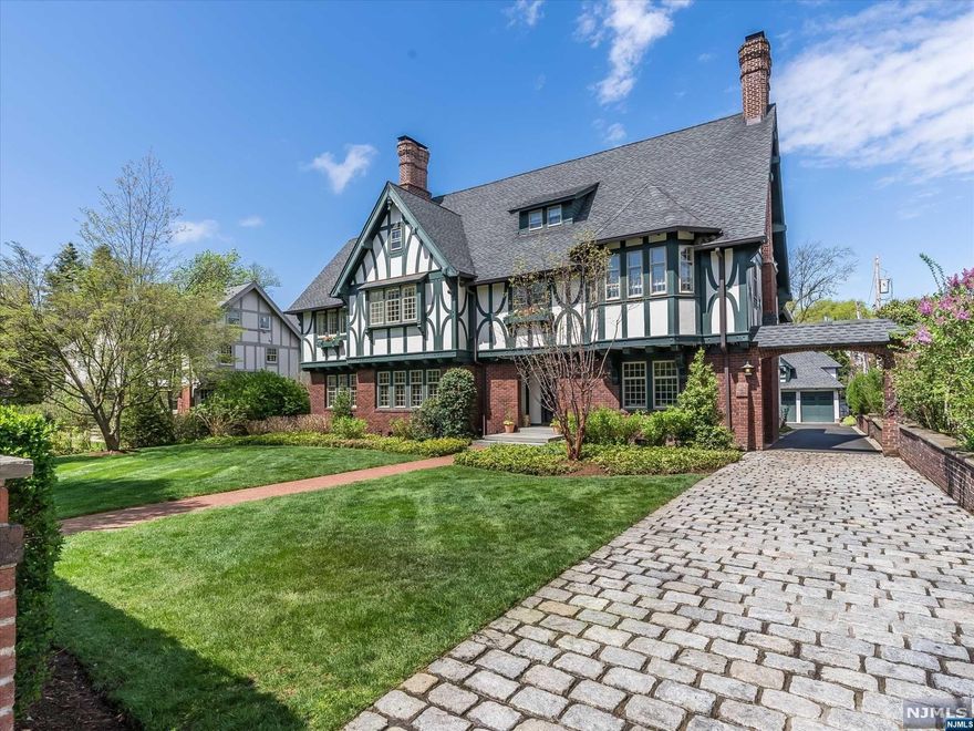 This notable residence offers wonderful craftsmanship and quality design in a truly outstanding location. Gracious foyer welcomes you with beautiful woodwork and incredible architectural details. First floor highlighted by large scale rooms include Living Room with fireplace and French doors to den/sunroom, formal Dining Room, and state of the art kitchen featuring high end appliances, inset cabinetry, marble center island and separate sunny dining area. Mudroom off the kitchen. Hotel-like primary suite features large, mahogany bath with double sinks, laundry, walk in closet, and connecting office/sunroom. Lushly landscaped property with mature plantings and expansive backyard bluestone patio offers complete privacy. Carriage house above 3 car garage with separate entrance and utilities houses a bedroom, full bath and kitchen perfect for nanny or guest quarters. Great location...walkable to downtown Montclair shops, restaurants and entertainment!