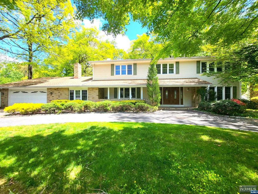 Fabulous home with indoor pool! Excellent neighborhood! Circular driveway to front porch welcomes you into large foyer. Wood floors throughout, HUGE Formal Living Rm with fireplace, spacious updated Kitchen w/Granite and large center island, sliders to wide back deck overlooking private, terraced backyard. Formal Dining with crystal lighting. Step down to large Fam Rm with fireplace and sliders open to Pool-Bar Room and indoor pool! Not to miss! Upstairs are 4 lg Bedrooms incl primary with TWO large walk-in closets and updated bathroom with double vanity. Basement is finished as Game Rm/Rec Rm. This house was meant for entertaining with pool area surrounded by sliding glass doors that open to paver patio. Lg Laundry/Mudroom on main level w/access to backyard also. Don't miss this beauty!