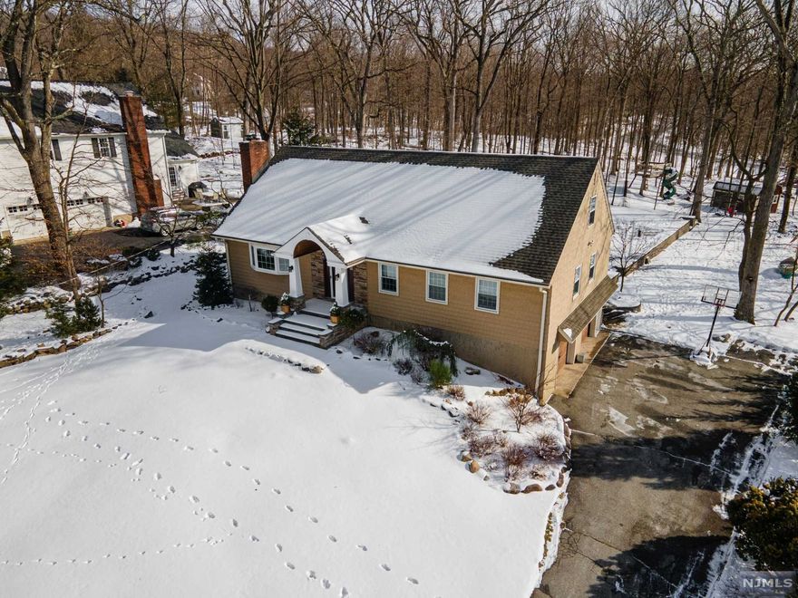 Incredible expanded ranch tastefully updated and completely move in ready on a quiet dead end street in sought after Pines Lake! This home offers 3 bedrooms on first floor with hardwood floors throughout, formal living room with wood-burning fireplace, large formal dining room, family room with access to deck, large updated eat-in kitchen, laundry room, full bath and master suite with another full bath! Basement fully finished with large rec room and full in-law suite with separate entrance and it's own full bath! Also a full walk-up attic that offers a ton of storage and endless possibilities for finishing the space or adding a second level! The property is roughly a half acre which offers a huge composite deck, patio, hot tub (2021), storage shed, playground and invisible pet fence! Other features include All in one boiler/tankless hot water heater (2021), external generator hookup, access to Tree Trails and High Mountain Reserve Park through backyard! Too many features to list!