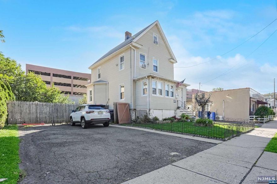 Amazing opportunity to own this colonial home with an oversize lot. "This is a recently renovated one-family home located just minutes from NYC, located near Hackensack High School as well as Hackensack Medical Hospital. 3 Bedrooms 2 Full baths With updated kitchen spacious dining room and hardwood floors, it combines modern appeal with classic charm. The house offers spacious areas finished basement and finished attic. very wide driveway and an extra-large backyard, and a front enclosed porch, super center and near parks, school, hospital and commuter friendly.