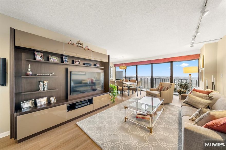 Rarely available, this beautifully updated 1 bedroom residence captures sweeping west facing views and effortless everyday living in the heart of Hackensack. Flooded with natural light, the open concept layout is framed by dramatic floor to ceiling windows and a sliding glass door, creating a seamless connection to the private balcony and showcasing stunning sunset views. The living and dining areas flow comfortably together, ideal for both relaxing and entertaining. Thoughtfully updated throughout, the home features modern flooring, a well appointed kitchen with ample cabinetry and workspace, and a generously sized bedroom complete with custom closet organizers. This home also includes one indoor parking space and additional storage, and is part of a full service building offering a 24 hour doorman, outdoor pool, fitness center, and resident lounge. An express bus to New York City is conveniently located just outside the lobby, making commuting simple and efficient. Perfectly positioned near transportation, Hackensack University Medical Center, shopping, dining, and major highways, this location offers both convenience and accessibility. Furnishings are available for purchase, presenting a turnkey opportunity.