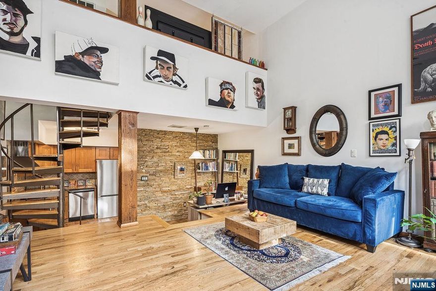 Located in Newark's vibrant Ironbound neighborhood, this distinctive 1-bedroom loft at the historic Chocolate Factory blends character, comfort, and convenience. Just 2 blocks from Penn Station and 15 minutes from Newark Airport, it offers easy access to NYC, major highways, shopping, restaurants, Prudential Center, and NJPAC. Soaring 20-ft ceilings and floor-to-ceiling windows fill the space with natural light and overlook a peaceful courtyard - one of only three units with direct access. Features include hardwood floors, a brand-new bathroom, updated kitchen with newer stainless steel appliances, vented range hood, lofted bedroom, and charming details such as an exposed original factory beam, a brick wall, and built-in wine rack. Recent upgrades: a newer water heater and furnace system. On-site laundry and tandem garage parking complete this stylish, contemporary loft in the heart of the Ironbound. * Architectural plans (a $2,500 value) are included for future projects.