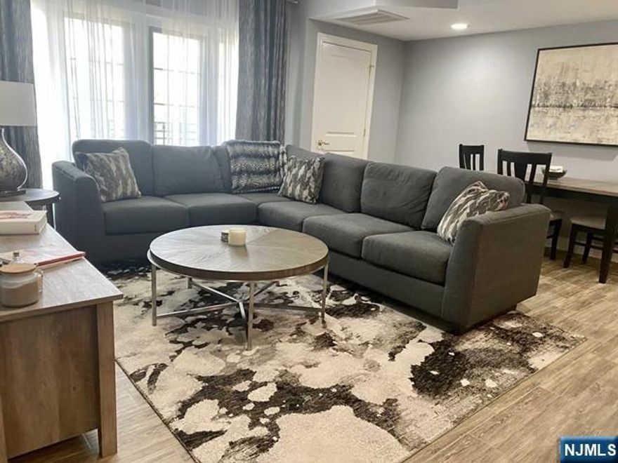 You will LOVE this chic 2 Bedroom, 2 Full Bathroom unit with open living space. Gourmet kitchen with newer stainless steel appliances, plenty of cabinetry & counter space and breakfast bar seating open to the living room and dining area. Primary Bedroom Suite offers a spacious bedroom, walk-in-closet and full bathroom en suite. The second bedroom is on the opposite side of the apartment and has a walk-in closet with the 2nd full bathroom just outside it's door. Additional features include Washer and Dryer in unit; plenty of closet space; outdoor Terrace perfect for yoga or a cup of coffee; great lighting; newer flooring; and two assigned parking spaces, including one covered parking space. This is a first floor unit and easily accessible. The Ambiance provides luxury living, an exercise room and a convenient location. Close to everything - shopping, transportation, restaurants, highways, Hackensack Hospital and so much more! Essex Street train station is around the corner.