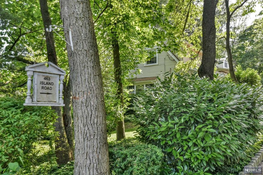 Absolutely charming colonial with 3 BR's and 2 Full Baths. Windows galore offering lots of natural light. Hardwood floors, moldings, and arched doorways, wood burning fireplace, 3 season sunroom, patio with Koi pond, oversized 1 car detached garage, gorgeous, mature landscaping, private oasis. Bedrooms have large closets! Location is close to park, shopping, public transportation, schools, Main Street and all that Ramsey NJ has to offer. Full, unfinished basement is waiting for your touch!