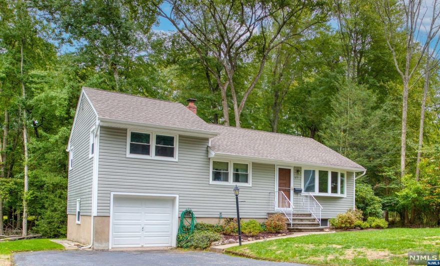 Well maintained Ranch nestled on a lovely manicured property with protected woods in the backyard for extra privacy (town owned). This bright and sunny ranch features large living room, dining room, eat in kitchen with Cherry Cabinets and door to backyard, three bedrooms and full bath. Full unfinished basement, great opportunity to finish for extra living space. One car attached garage. Close to NYC transportation, shopping, etc. Living Room, Dining Room and Hallway freshly painted. Hardwood floors throughout. Municipal water line in street if buyer wants to connect. Welcome Home!