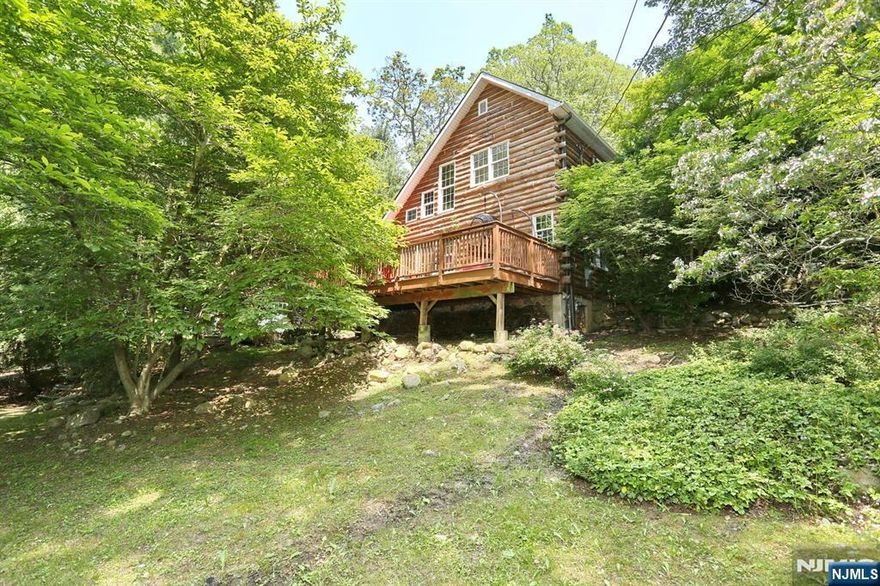 This charming log home is located in an area of Ringwood with potential to join Cupsaw or Erskine Lakes (membership optional/not guaranteed).The main floor of the home boasts and open floor plan with high ceilings, wood beams, plenty of natural light, and a wood-burning stove. The kitchen, a full bathroom, and laundry/utility room complement the open living/dining area. Step out onto the deck and enjoy the tranquility the yard provides, it feels like you are in a treehouse! From upstairs you can admire the main floor from the loft area. The second floor has two bedrooms with ample closet space, an open office area, a full bathroom completes this level. The private balcony off the primary bedroom overlooks the wooded lot. Situated on almost an acre of land there are plenty of gardens, a detached garage with another full attic, and an open-air cabana. As you walk the grounds, nature abounds, a chicken coop can be found amongst the private oasis.