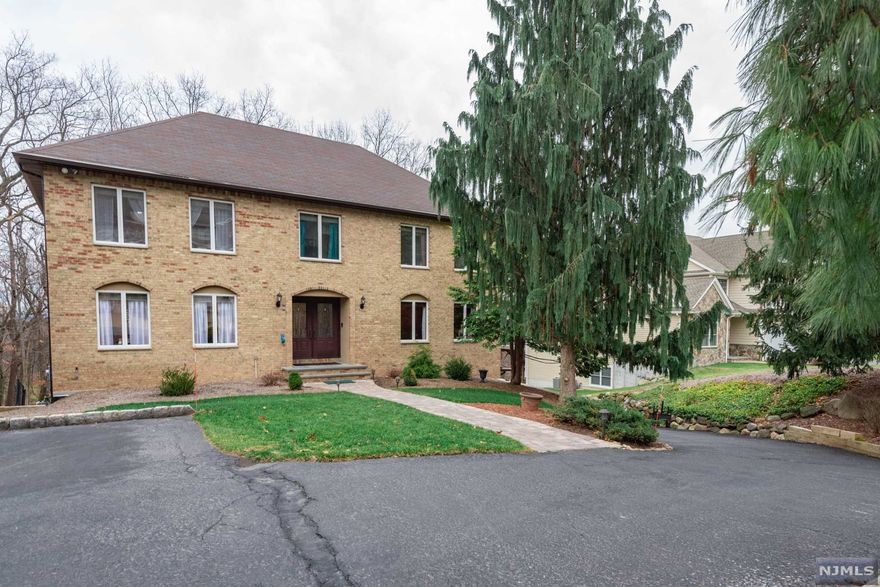 Come see this meticulously maintained 4 bedroom Brick Colonial nestled in a lovely neighborhood setting on a quiet cul-de-sac location just moments from schools, transportation, and parks. Enter into a large foyer with a great den to your right and a gracious dining room on your left. Straight ahead is a large open concept eat-in kitchen with granite counters, tile backsplash & stainless appliances and a SGD that leads to a large deck where you can catch a glimpse of the NYC skyline. The cozy family room w/ fireplace is located just off the kitchen, a PR & laundry complete the 1st floor. Upstairs features a large primary suite along with 3 other spacious bedrooms and a hall bath. The lower level is finished with grade-level access to a private yard. Walk to the beautiful Goffle Brook Park with its walking paths, dog run, and picturesque Arnold's Pond. Nothing to do but unpack at this stylish and impeccable home. Come see for yourself as this home is surely more than meets the eye