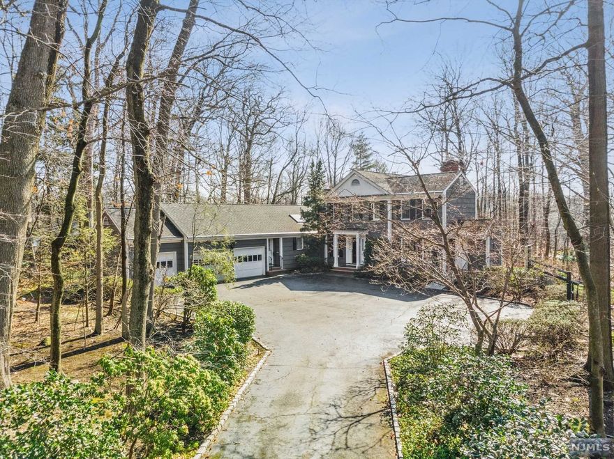 Endless possibilities on over 1 acre describes this charming center hall gem. The large formal entry foyer allows access to all main rooms. This open floor plan is surrounded by walls of glass. Pristine hardwood floors and wood paneled office are just some of the designer attributes of the home. Large kitchen, 1st floor bedroom suite and 3 car garage complete the main level. The upstairs features a large master suite and bath with 2 more bedrooms and hall bath. A wrap around deck and salt water pool offer great outdoor entertainment. A must see.