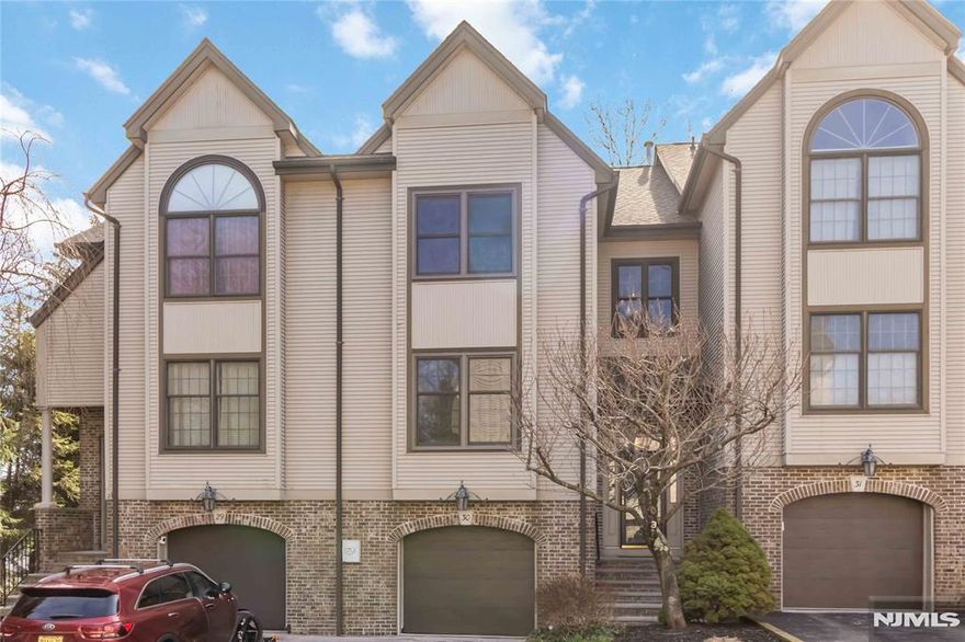 Welcome to this spacious 2-bedroom, 2.5-bath townhouse offering a wonderful blend of comfort, light, and opportunity. A dramatic open-concept living and dining area creates an airy, inviting feel, complete with a fireplace and access to a private terraceâ€”perfect for relaxing or entertaining. The main level also features a bright eat-in kitchen and a functional layout ideal for everyday living. Both bedrooms feature cathedral ceilings and striking arched windows that fill the rooms with natural light and add architectural character. The primary suite offers a comfortable retreat, while the second bedroom is generously sized and versatile, both with plenty of closet space. The finished basement provides a spacious family roomâ€”ideal for a media space, home office, or play areaâ€”along with additional storage. A one-car garage adds everyday convenience. Offering great space and endless potential, this home is ready for your personal decorating touches to truly make it your own and create a beautiful showplace. Set in a desirable River Edge community with top-rated schools, low-maintenance townhouse living, and close proximity to NYC transportation, this is the one you've been waiting for!