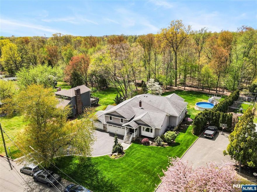 Maintenance free home with stone and siding exterior, Anderson windows, and 30 year roof on oversized 100x262 lot with 10 zone sprinkler system. Backyard features saltwater pool, paver patio, and two covered decks. Whole-house generator. Interior offers living/dining rooms, scullery, and open-concept great room with high-end kitchen, custom cabinetry, granite countertops, pantry, and gas fireplace. Main-level primary suite with jacuzzi and separate shower. Entertainment are 25x52 Second floor includes an en-suite, 2 bedrooms, full bath. Additional features: 3-car garage (epoxy), central vac, reverse osmosis, alarm, 4-zone A/C, 7-zone heat, high-efficiency boiler. Close to shopping, dining, and library. A must see!