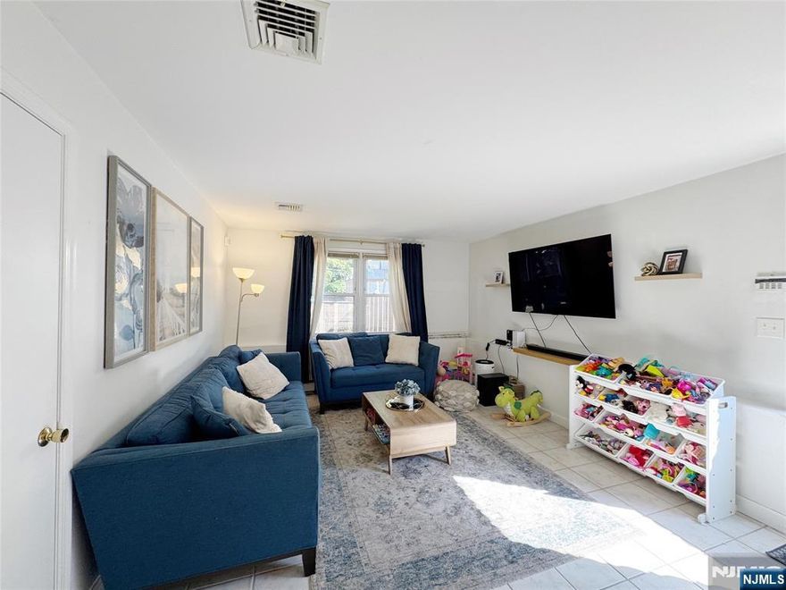 Spacious first-floor apartment in a well-maintained two-family home, featuring 2 bedrooms, 1 full bath, sizeable living room, and a modern kitchen with a breakfast area. In-unit washer and dryer. Central A/C. Exclusive use of the backyard. Water and one parking space included (possible 2-car tandem parking). Conveniently located near NY buses, schools, parks, and more. No pets permitted.