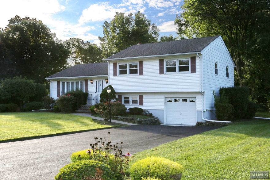 Located in a premier interior neighborhood, in one of Morris County's most coveted towns, this classic Pompton Plains split-level home sits on over 1/2 acre of gorgeous flat property and offers great value that will appeal to today's most discerning buyer. This special home offers a total of 3 bedrooms, 2 1/2 baths, both formal living and dining rooms, eat-in-kitchen, and cozy family room that can also be used a 4th bedroom or home office. A spacious three season porch overlooks the massive backyard. Additional value items include original hard-wood floors under the existing carpet, central air, attached one car garage, and public water. The home will be delivered with an updated and/or new septic system. Pompton Plains is well-known for its' highly regarded school system, exceptional recreation programs and facilities, a wide variety of great shopping and restaurants, and easy access to all highways. Make some cosmetic changes, renovate, or expand...the options are limitless!!!