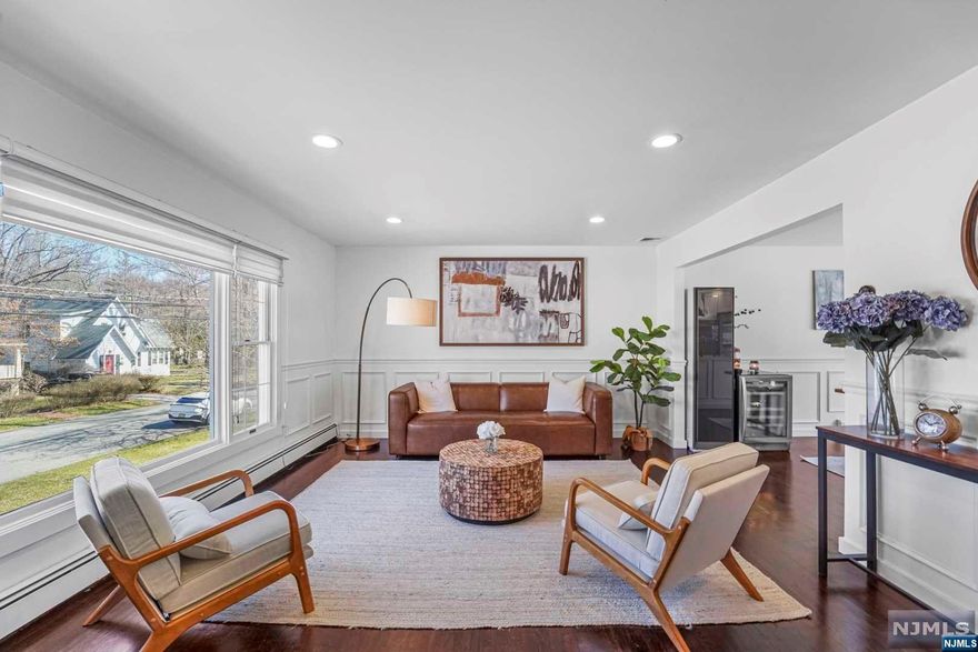 Fully renovated in 2021, this bi-level home offers 4 bedrooms, 3 bathrooms, a spacious living room, formal dining room, and an eat-in kitchen that leads to a stunning deck. The family room features a cozy brick fireplace, 2-car garage, and a newly-permitted fence for added privacy. The chef's kitchen is equipped with top-of-the-line appliances, including a family hub refrigerator, wall oven, induction cooktop, dishwasher, and wine cooler. Laundry is made easy with a high-end washer and dryer, as well as an air dresser. The lower-level bathroom has been converted to a full bathroom, providing extra flexibility. Enjoy easy access to NYC transportation, shopping, schools, and parks - this is the ultimate suburban home.