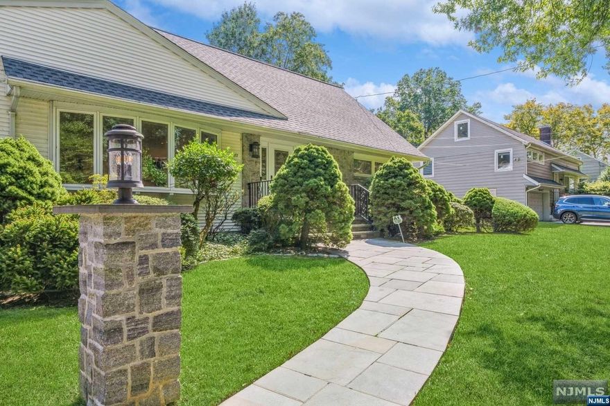 Welcome to this charming Cape Cod-style home located in the desirable Manor section of Haworth. This well-maintained 4-bedroom, 2.5-bath residence sits on a beautifully landscaped 100x100 lot. The spacious living room boasts a stone gas fireplace, while the formal dining room and eat-in kitchen flow seamlessly into a large family room with vaulted ceilings and a wall of windows overlooking the patio and backyard. The first floor includes two bedrooms and a full bath, with two additional generously sized bedrooms and another full bath on the second floor. The oversized basement offers a versatile family room and ample storage. Additional features include central air, hardwood floors, abundant closet space, and a gas generator.