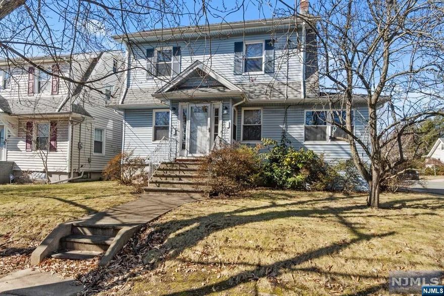 Opportunities abound for the visionary ready to restore this large 3 Bedroom, 1 Bath home to its grandeur. Located on an oversized, corner lot, this home retains the charm of yesteryear with high ceilings, a coffered dining room ceiling, wood burning fireplace in the living room, original hardwood floors, walk up attic and a large front porch. Modern conveniences include a newer hot water heater, newer vinyl siding and an attached garage. Rounding out this offering is a patio and large, level backyard perfect for outdoor entertaining. Photos have been virtually staged to assist with seeing this home's potential.