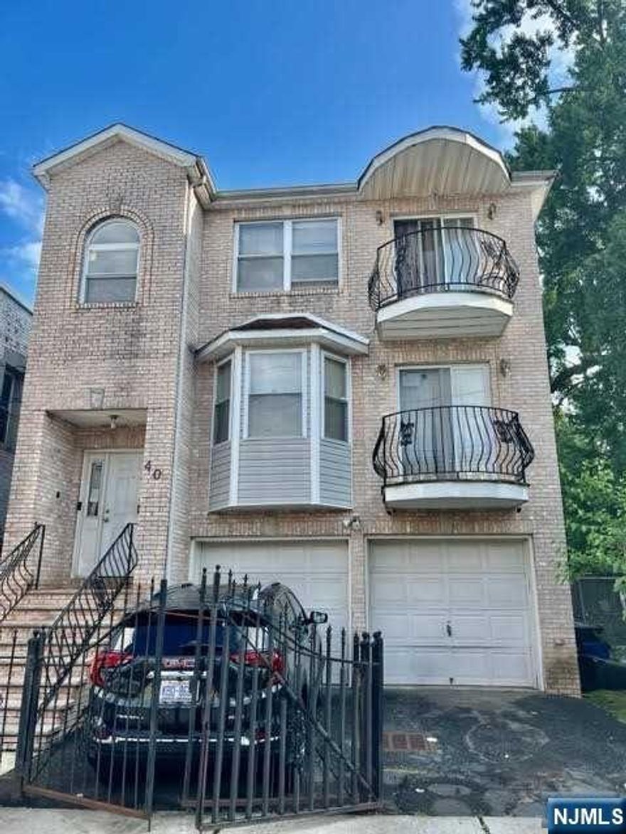This income-producing 3-family home built in 2004 with a brick front, a 2-car garage, and a fenced-in driveway for 2 cars offers a blend of modern comforts, aesthetic appeal, and income-generating potential, making it an attractive investment in the bustling city of Newark. Each unit likely comprises a comfortable living room area, providing a relaxing space for residents to unwind and spend quality time. The living rooms could be well-ventilated and well-lit, creating a cozy ambiance for occupants.