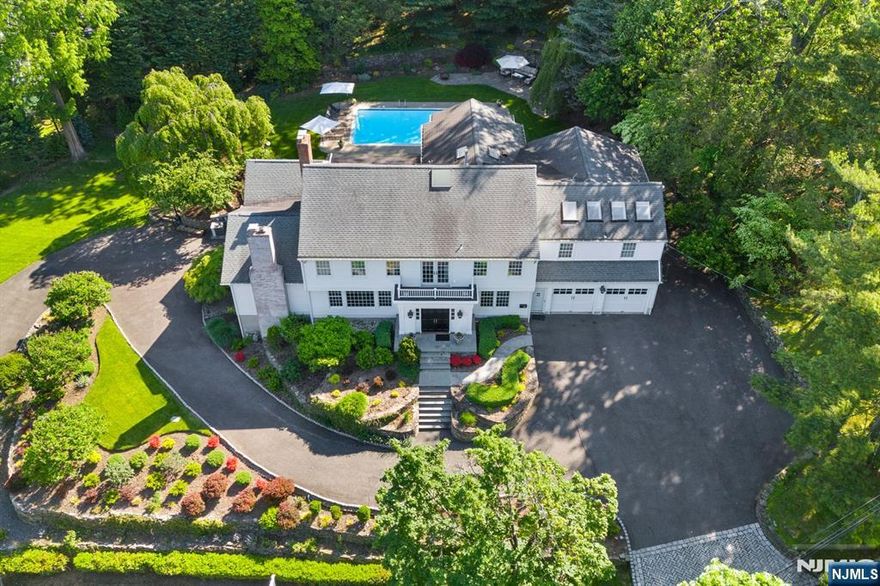 Discover the perfect blend of space, privacy, & luxury in this expansive & updated Colonial, nestled on a serene East Hill cul-de-sac. Perched on a private 1 acre lot, this home offers breathtaking sunset views & an inground pool, creating the ultimate retreat. W/ 7 beds, 4.2 baths, & generous living spaces, boasting hardwood flrs, soaring ceilings, & elegant finishes throughout. A stunning den w/ cathedral ceilings & exposed beams showcases flr to ceiling windows w/ incredible views. The renovated chefs EIK fts a center island w/ marble counters, high end appl., & 2 dishwashers, opening to a sunlit breakfast area & spacious FR & den. The grand primary suite includes cathedral ceilings, WIC, & a spa like bath w/ a soaking tub & skylights. A finished lower level offers a rec room & walk out access. 2 car attached garage plus a tandem 2 car sports garage, generator, & new epoxy floors are just a few highlight features. Moments from top rated schools, NYC, and houses of worship.