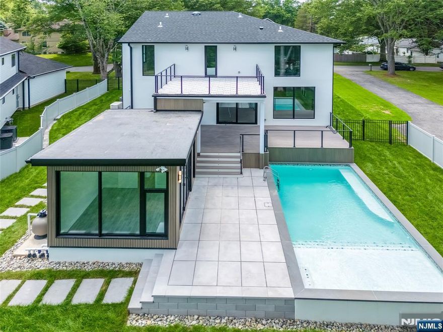 Welcome to this stunning modern masterpiece nestled on a beautiful tree-lined street in the heart of Norwood. Expertly crafted by Lumaj Properties, this home is a true showcase of luxury and design, featuring 6 spacious bedroomsand 7 full bathrooms, along with a private cabana. Set on a picturesque property with endless views, this residence offers a roughly 5,000 livable square feet of living space with custom architectural style and a seamless blend of indoor and outdoor living. As you enter, you're greeted by soaring 11-foot ceilings and an open floor plan enhanced by floor-to-ceiling windows that flood the home with natural light. No detail has been overlookedâ€”this home is loaded with top-of-the-line amenities, including a Wolf and Sub-Zero chefâ€™s kitchen, gunite pool, outdoor kitchen, private cabana, home theater, and gym. Designed with impeccable attention to detail, this home exceeds all expectations. Located in the desirable town of Norwood, you'll enjoy access to award-winning schools and close proximity to shopping, dining, and easy access to NYC.