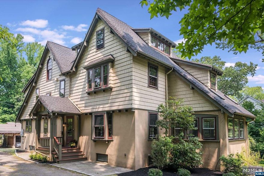 Located in an idyllic setting, this 5-bedroom, 3.5-bathroom craftsman colonial home is loaded with charm! Spacious primary bedroom with ensuite spa-like bath, walk-in closet & wood-burning fireplace, a large renovated kitchen, all renovated bathrooms including a first-floor powder room, central air, private rear deck, sunroom with vaulted ceiling, and screened-in porch - this home has it all! Features include radiant heated floors in the kitchen and sunroom/den, mudroom at the rear entrance, a first-floor laundry center, incredible loft access from the bedroom, and a Juliet balcony! One of the best blocks in town - convenient to everything the village has to offer from shops, restaurants, parks, and NYC transportation. Welcome home!