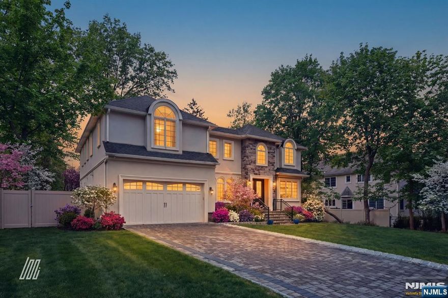 info@8ranchlanecloster.com // Welcome to this stunning East Hill Closter residence, built in 2022 & offering over 3,700 sqft of beautifully designed living space on a quiet dead-end street. This nearly new home impresses from the moment you enter, featuring a dramatic 2-story family room with custom fireplace, soaring ceilings, and walls of arched windows that fill the space with natural light. The open-concept layout flows effortlessly into the formal dining room with coffered ceilings and elegant millwork-perfect for both everyday living & entertaining. The chef's kitchen is the heart of the home, showcasing custom cabinetry, oversized center island, quartz countertops, premium SS appliances, and a striking statement range hood. A rare secondary prep kitchen & butler's pantry offer exceptional functionality & storage-an ideal feature for entertaining. Upstairs, four generously sized bedrooms include a luxurious primary suite complete with a spa-like bath featuring a freestanding soaking tub, glass-enclosed shower, and an expansive custom walk-in closet. Every bathroom is finished with modern tile & designer details. The fully finished lower level provides flexible space ideal for a recreation room, gym, or media room with a full bath. Step outside to enjoy a private, fenced backyard with elevated deck-perfect for outdoor dining, play, or relaxing evenings. Located in Closter's highly sought-after neighborhood, close to top-rated schools, parks, shopping, and dining.