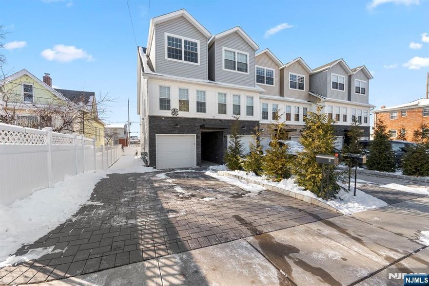 Discover modern living in this stunning end-unit townhome built in 2020. The ground floor offers a garage entrance, stackable laundry, a full bathroom, and a bedroom that opens to an outdoor patio. The second floor features a bright living room, an open-concept kitchen and dining area with sleek finishes, and a powder room. A private deck extends from this space, ideal for relaxing or entertaining. The third floor includes a spacious main bedroom with a walk-in custom closet, a full bathroom, and another bedroom with its own custom closet. A full-house water softener system enhances comfort. Located near Garfield train stations and NYC-bound buses, this home is perfect for commuters. Nearby parks, shopping, and dining complete the package, offering the perfect blend of style, comfort, and convenience. Donâ€™t miss this incredible opportunity!