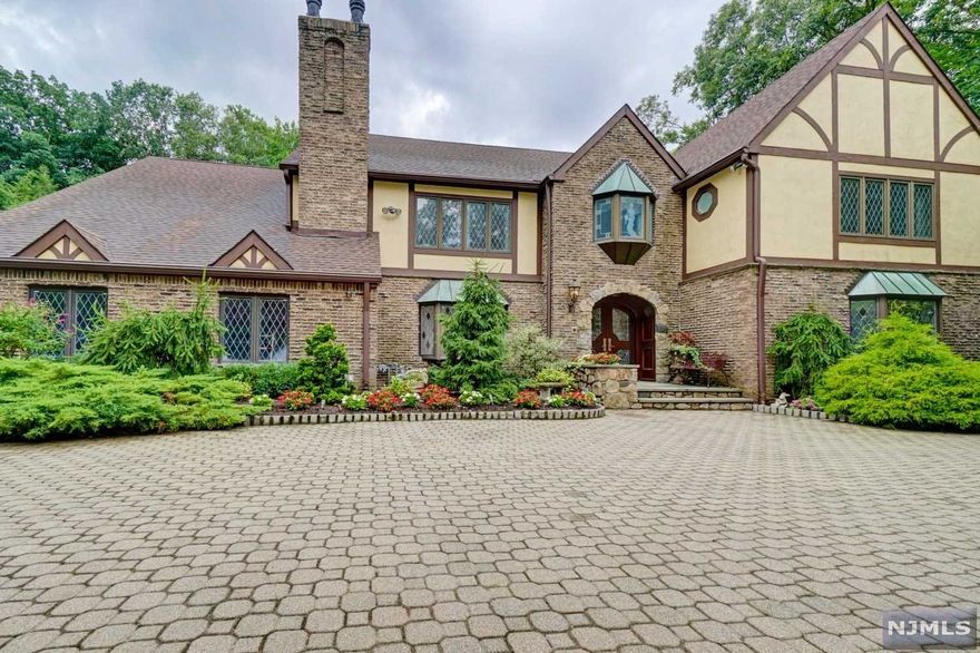 Pristine English Manor, totally renovated & updated, boasting 6 Beds, 7 FBs/2 HBs at approx. 8,200 Sq. Ft. sitting on 2 lush country club-like acres of land! This home includes a 2 Bed/2 Bath Guest/Pool House that overlooks breathtaking grounds & kidney shaped in-ground pool. As you enter you'll be greeted with a 2-story entry foyer and elegant staircase. The main floor boasts a Modern Eat in Kitchen, Fml L/R w/ Fire Place & Custom Wet Bar, Fml d/r, Study, Sun filled Great Room with walls of glass overlooking your private Oasis of a yard, (2) Pwdr Rms, Laundry which leads to a 6 Car Garage (2 Tandem). As you make your way upstairs your greeted with a Spa-like Master Suite w/ oversized closets/built-ins, Newer Master Bath which leads to a large mirrored Gym w/ FB/seperate entrance. Addtly 3 oversized BDRMS (2 w/ Ensuite). Exquisite finished basement, wine cellar, FB. Outdoor Kitchen, Paver Driveway, ALL NEW mechanicals, truly a MUST SEE!