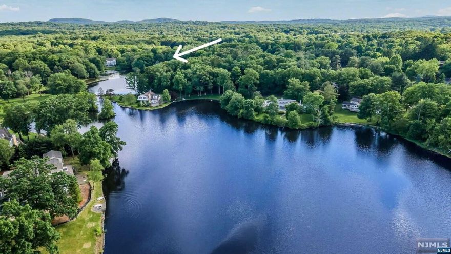 6 ACRE LAKEFRONT! With over 600 ft of WATERFRONT on 6+ acres, this property offers breathtaking views of Shadow Lake, encompassing almost the entire western shoreline of one of the two connecting lakes. This exceptionally private property has been in the family for over a 1/2 century and was previously owned by the parents of actress Jane Wyatt, known for her roles in "Father Knows Best" and "Star Trek." Embrace the historical significance found here, refurbish the existing home, or build anew to create your dream home in this premier location, surrounded by multi-million dollar lakefront neighbors. As part of Shadow Lake Estates, enjoy membership-only access to the lakefront clubhouse, pool, boating, fishing, tennis, basketball, pickleball and more. Imagine a setting of this caliber offering such privacy, exclusivity, and tranquility in the thriving town of Franklin Lakes, all just 25 miles from Manhattan. Property sold strictly as-is. Inspections for informational purposes only.