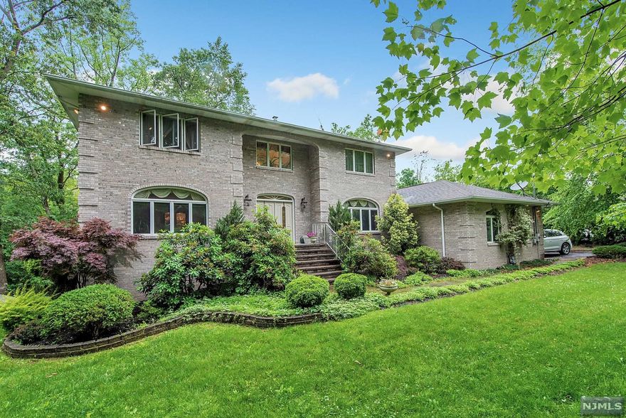 Sensational Brick Quality built colonial on private lot in Montville Township. 2 story foyer w marble floor greets you into this spacious entertainers dream where light abounds. Center island kitchen w granite counters and updated cabinets. Sliding doors from kitchen to large private deck with gas line for grill. Kitchen opens to family room with vaulted ceiling, skylights and 1 of 2 brick fireplaces. Completing the 1st floor is a private "junior" suite with full bath and backyard access. 2nd level consists of 4 generous sized bedrooms and 2 full baths. HW floors throughout the home. Full Walk out basement with steel beam construction, high ceilings and windows affording lots of light. Much more potential to be finished. Currently has rec room with fireplace, laundry and full bath. 3 zone heat, 2 zone newer central air, central vac, security system, custom landscape lighting and 3 car garage. Montville is a Top Rated town with award winning schools all within 30 miles of NYC!