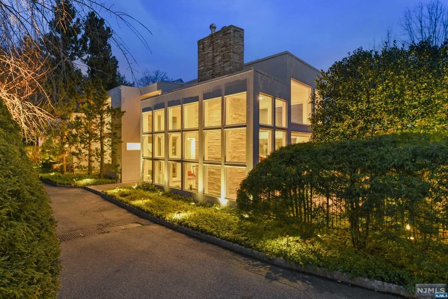 Sensational custom built contemporary with sparkling floor to ceiling windows and NYC views. Open and spacious floorplan with sunken living room with fireplace and Koi pond! Family room with fireplace adjoins updated kitchen. Primary bedroom suite with an amazing bathroom, walk-in closet and office with expansive deck complete the 2nd floor. Fantastic finished lower level with media and game room plus walk-out to pool, patios and bocce court. Extraordinary landscaping with unique specimen trees plus elaborate exterior lighting. One of a kind and special in every way. Not to be missed!