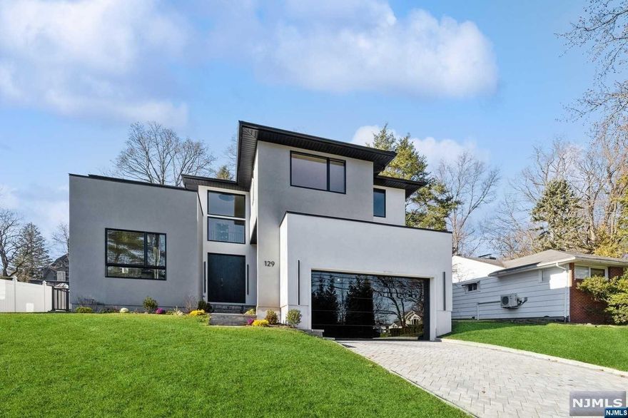 Discover Tenafly's newest construction. This sprawling property spans over 4,000 square feet and boasts 5 bedrooms and 4.5 bathrooms. The heart of the home is the open-concept living and dining area, creating an ideal space for hosting guests. The chef's kitchen is equipped with top-of-the-line stainless steel appliances, a generous island, and abundant cabinetry. Property features a fully finished basement. Within, a spacious rec room, a state-of-the-art home theater, and an additional guest bedroom. Location is second to none, situated just minutes away from Tenafly's finest offerings, of top-rated schools, an array of dining establishments, and shopping destinations. For those who commute, Tenafly offers easy access to major highways and swift transportation options to the heart of NYC. This Tenafly gem promises a lifestyle of luxury, comfort, and unmatched convenience.