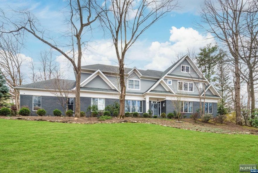 This bespoke residence epitomizes luxury, blending sophistication and warmth with a stunning design. Built and recently transformed, every detail, from unique wall textures to designer finishes, was carefully selected. It features a chef's dream kitchen, opening into a grand family room, and offices on the first and second floors, suiting modern work-from-home needs. The primary suite offers a sitting room, office, custom boutique-style dressing room, and luxurious bath. All four additional bedrooms are en-suite, with a first-floor bedroom for convenience. The home includes a spacious walk-up attic for storage, a lower level with recreation spaces, an exercise room, and a home theater. Outdoors, a large patio and flat lawn cater to entertaining and relaxation. Equipped with Google Nest for smart temperature control and a 9-camera CCTV system, this home merges comfort with high-end living.