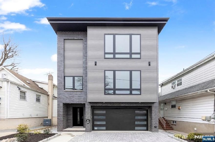 JUST COMPLETED!!!! NEW CONSTRUCTION, BUILT BY PREMIER BUILDER. THIS LUXURIOUS HOME BOASTS 3 LEVELS OF LIVING SPACE......GROUND ENTRY WELCOMES YOU TO THE ENTRY HALL TO THE SUNKEN RECREATION RM WITH BAR W/WINE FRIG, SLIDING GLASS DOOR TO REAR PAVER PATIO, NICE SIDE YARD, FULL BATH, HALL CLOSET, MUDROOM W/CLOSET, ACCESS DOOR TO A 1 CAR GARAGE, 2 TANDEM PARKING DRIVEWAY, UTILITY ROOM...... 2ND FLOOR MAIN LEVEL-HAS A HOME OFFICE WITH FLOOR TO CEILING GLASS WALL, OPEN CONCEPT LIVING ROOM W/ELECTRIC FIREPLACE, DINING ROOM, POWDER ROOM, MODERN KITCHEN WITH OVERSIZED ISLAND, PANTRY, FAMILY ROOM WITH ELECTRIC FIREPLACE AND SLIDING GLASS DOOR TO DECK....3RD FLOOR-THE HALLWAY SKYLIGHT PROVIDES PLENTY OF LIGHT, 2 BEDROOMS WITH WALK IN CLOSETS, FULL BATHROOM WITH A DOUBLE SINK VANITY, TUB/SHOWER COMBO, HALL LINEN CLOSET, SPACIOUS LAUNDRY ROOM WITH CABINETS & FOLDING COUNTERTOP, PRIMARY SUITE WITH HIS/HER WALKIN CLOSETS, CLOSET, BATHROOM W/SKYLIGHT, HIS/HER VANITY, SHOWER AND TUB.