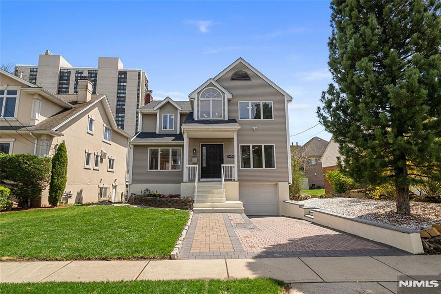 Experience timeless charm and modern updates in this fully renovated Center Hall Colonial, nestled in one of Fort Leeâ€™s most sought after neighborhoods. Renovated in 2022, with a new roof added in 2023, this sun filled home offers refined finishes and inviting living spaces throughout. The main level boasts a spacious living room, formal dining room, cozy family room with a fireplace, and sleek gourmet kitchen featuring stone countertops, stainless steel appliances, and center island. Sliding doors open to a large, private deck ideal for entertaining. Upstairs, the primary suite includes a walk-in closet with French doors, while two additional bedrooms share a beautifully updated full bath. The ground level offers a generous recreation room, full bath, laundry area, storage space, walk-out access to the backyard, and a large, attached garage with extra storage. Located just blocks from downtown Fort Lee, close to schools, and only a block from NJ Transit for a quick commute.