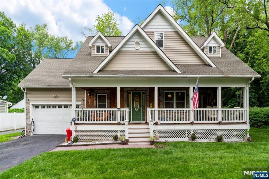 Nestled on a quiet one-way street with only three homes, this stunning riverfront property offers a rare blend of privacy, charm, and walkable convenience in the heart of Bloomingdale. Overlooking the Pequannock River, this home invites you to relax to the sounds of nature especially from the wraparound lemonade porch or the inground fire pit, both perfect for entertaining or enjoying quiet mornings. Inside, the thoughtful design blends rustic warmth with modern comfort, showcasing custom woodwork and molding throughout. The main floor offers a beautiful open flow between the living and dining areas, with a standout custom kitchen featuring heated floors. A former primary suite on this level now serves as an expansive rec room with walk-in closet and full bath, adding flexibility. Upstairs, three bedrooms share a dual-vanity bath, fully redone with his-and-hers sinks, barn door cabinetry, corner closet, and a rainfall shower. Additional highlights include multi-zone central air with smart thermostats, natural gas heat, public utilities, and an EV charger for electric vehicles. Enjoy the serene setting of Brandt Lane while being just a short walk to Main Street's restaurants, shops, post office, and more. Located in the Butler school district, this is a rare riverfront opportunity with beautiful mountain views.