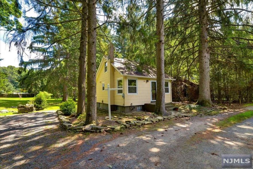 This charming 2-story home is a nature lover's delight! Featuring 3 bedrooms, 1 bath, this house sits on an expansive flat 1-acre perfect for any outdoor activity. Inside the home, the first floor offers 2 bedrooms, the living room, a galley kitchen with separate dining area, and a main bathroom, along with the third bedroom on the second floor- all with hardwood and carpeting throughout. Additional features include a back porch perfect for relaxation and a detached 2-car carport. What's more, this house is located in close proximity to the Weis Ecology Center with easy access to everything the nature center has to offer, including trails and a spring fed pool! You won't want to miss this one!