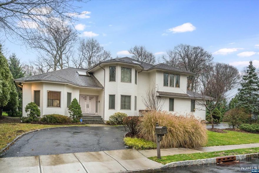 Welcome to 4 Ash Ave, where LUXURY meets COMPFORT! This light & bright contemporary nestled on a private cul-de-sac, offers a fantastic open floor-plan. The most discerning buyer will be impressed by the flow of approx. 4800 total sq feet! LOVE, LOVE, LOVE, the 3 levels of living and the soaring ceilings, exposed beautiful wood beams, and hardwood floors throughout. Special features include a gourmet kitchen, large island, family room with wood-burning FP, and wet bar in the dining room. And to make it even more special, enjoy the first floor en-suite that will suit every need! Head upstairs and find 4 additional large bedrooms including a primary suite with walk-in closets, balcony and large bath. The finished basement offers home office, gym, rec room, mini kitchen full bath and powder room. Feel right at home in this extraordinary home located in an upscale neighborhood! Step in, enjoy a tour and see the privacy, peace, and serenity that awaits you! Just 17 mi to NYC, clo