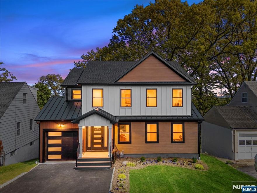 This spectacularly expanded residence has been meticulously renovated with exceptional attention to detail throughout. The modern open-concept floor plan is highlighted by beautiful oak floors, abundant natural light, and a seamless connection between the spacious living and dining areas. The expansive kitchen overlooks the main living space and features a sleek modern electric fireplace, creating a warm yet contemporary ambiance. A well-appointed first-floor bedroom with a private en-suite bath offers flexibility for guests or multi-generational living, complemented by an elegant powder room on the main level. The second floor is anchored by a generously sized primary suite showcasing winter skyline views of New York City and a luxurious spa-inspired bath with a soaking tub and oversized glass-enclosed shower. Three additional well-proportioned bedrooms and a stunning hall bath complete this level. The lower level offers a large family or recreation room, utility space, and walkout access to a beautifully designed, mostly covered patio overlooking the yard. Truly move-in ready, this home reflects thoughtful craftsmanship and refined finishes at every turn.