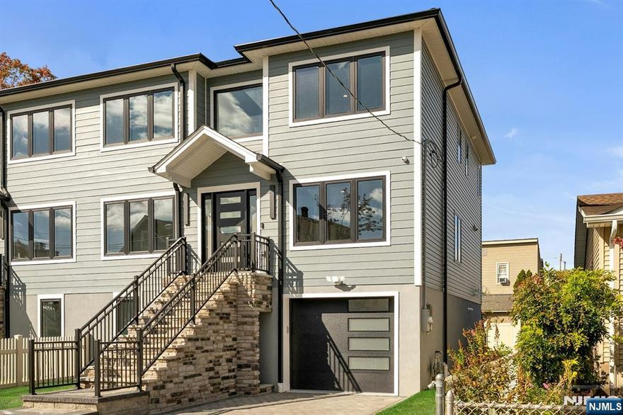 Brand new East-facing 4-bedroom, 3 full bath townhouse/duplex style condo with NO Maintenance fees! This quality-built home measures approx 2,400 sq ft (plus an additional 1,000 sq ft on ground level). Living room, dining room, den and separate family room combined with an open concept kitchen with custom cabinets, quartz tops with tiled backsplash, stainless steel appliances, which include stove, built-in microwave, dishwasher, and refrigerator with ice maker/water dispenser. The family room has an electric fireplace and sliders to 10' x 15' composite deck overlooking a deep yard. 2nd floor features 4 bedrooms, laundry closet with washer & dryer & 2 full baths. Master bedroom with 2 walk-in closets and private bathroom with shower stall. 2 gas forced air heating & air conditioning systems, gas tankless water heater, security camera system, hardwood floors on 1st & 2nd floor, 2nd floor pre-wired for house router. Ground level has access to the garage and walkout. 150 amp electric panel. Built in 1-car garage with a door opener, the driveway can accommodate a few cars. Lovely landscaped property. Located in a flood zone, all finished areas are above the flood elevation line, and flood insurance is quoted at $1255 per year! 2 blocks to NJ Transit bus stop #160 to NYC Bus Terminal in less than 30 minutes on average! Includes a 10-year new home warranty!